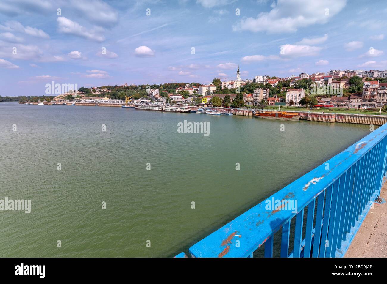 Looking from a bridge to floating houses and night clubs on Sava River at Belgrade, Serbia in a partially cloudy day. Stock Photo
