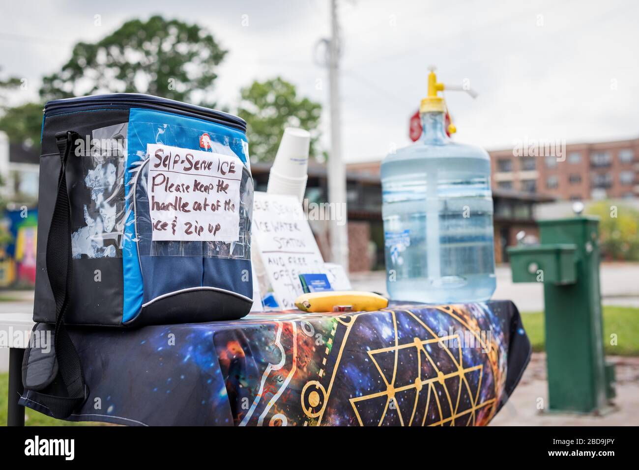 Houston, Texas, USA. 7th Apr, 2020. A makeshift community water station made for walkers, runners, and bikers along Heights Blvd in Houston, Texas, Thursday, April, 7, 2020. All water fountains in Harris County were shut off on March 24, 2020, when the Stay-At-Home order was put in place by Judge Lina Hidalgo. The new coronavirus causes mild or moderate symptoms for most people. Still, for some, especially older adults and people with existing health problems, it can cause more severe illness or death. Credit: Lynn Pennington/ZUMA Wire/Alamy Live News Stock Photo