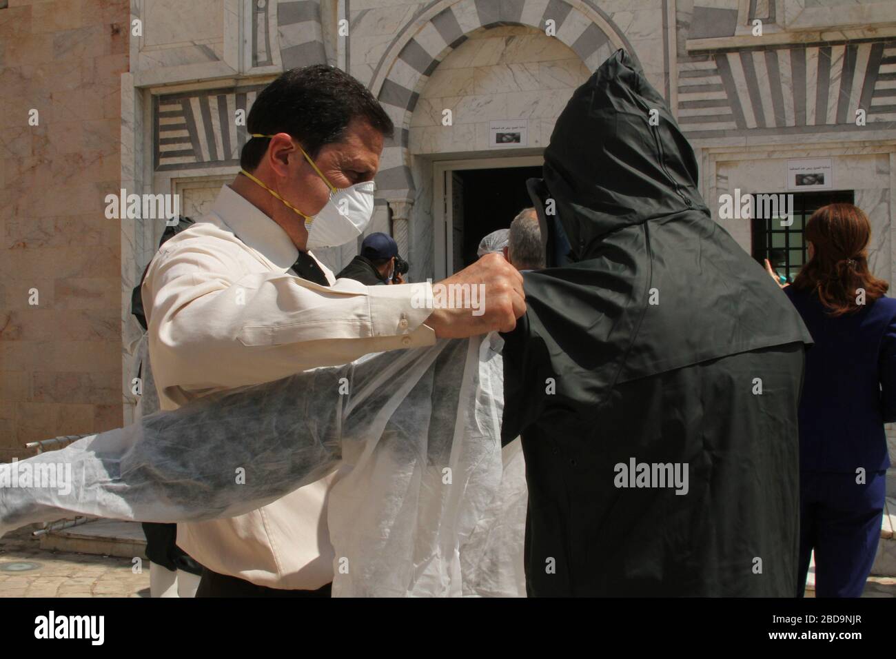 Health workers wearing protective suits as a preventive measure, during the white operation.A grand burial named ‘white operation’ for corona virus victims. Tunisia has recorded a total of 650 infected cases and 23 deaths by the covid-19 disease. Stock Photo