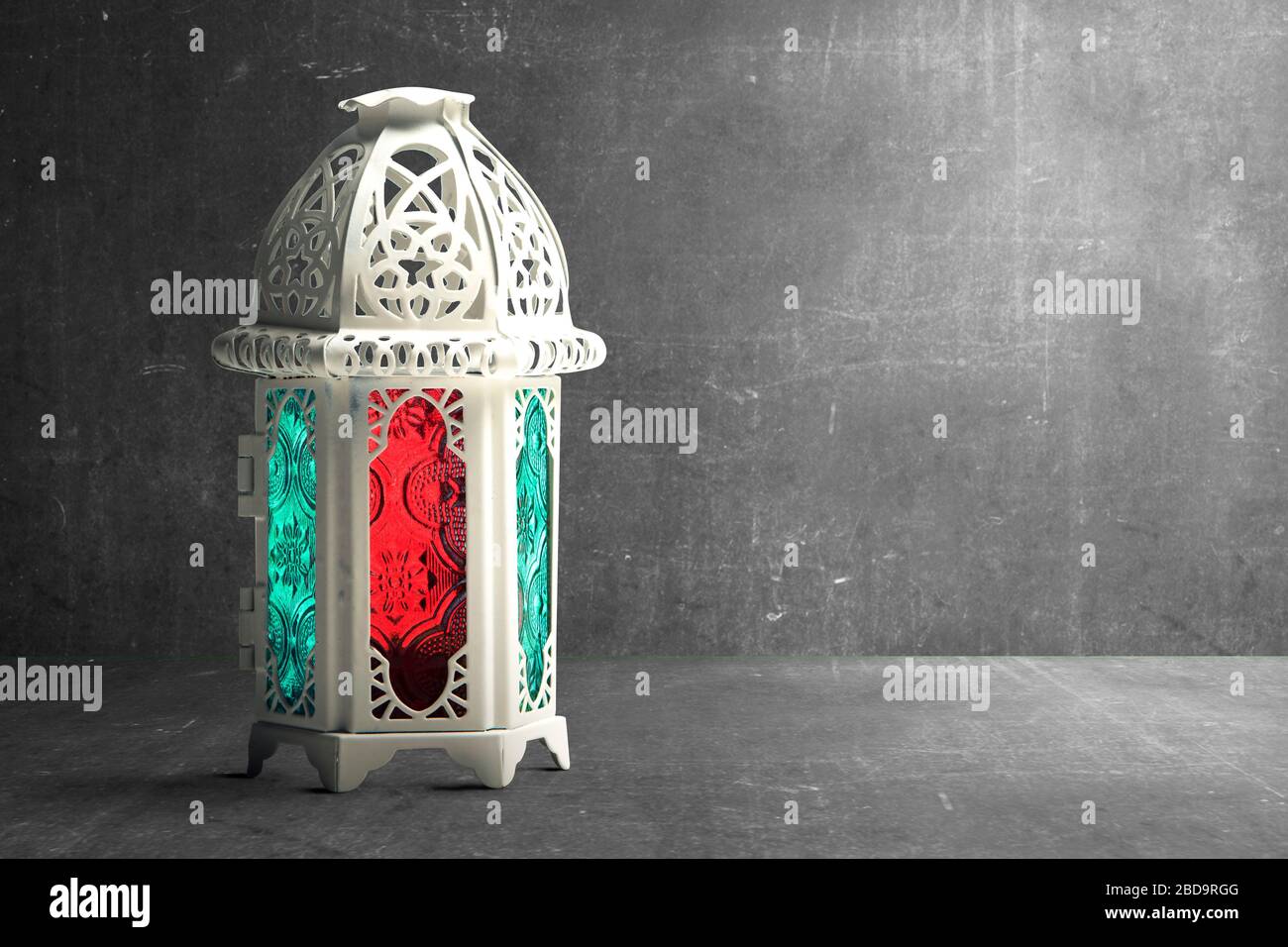 Arabic lamp with colorful light on black wall background Stock Photo