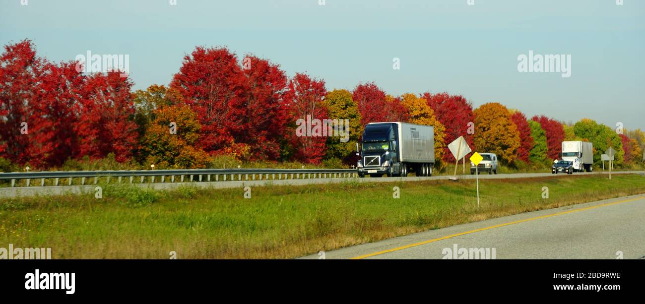 Ontario, Canada - October 27, 2019 - The panoramic view of traffic on the Route 401 highway with stunning colors of fall foliage Stock Photo