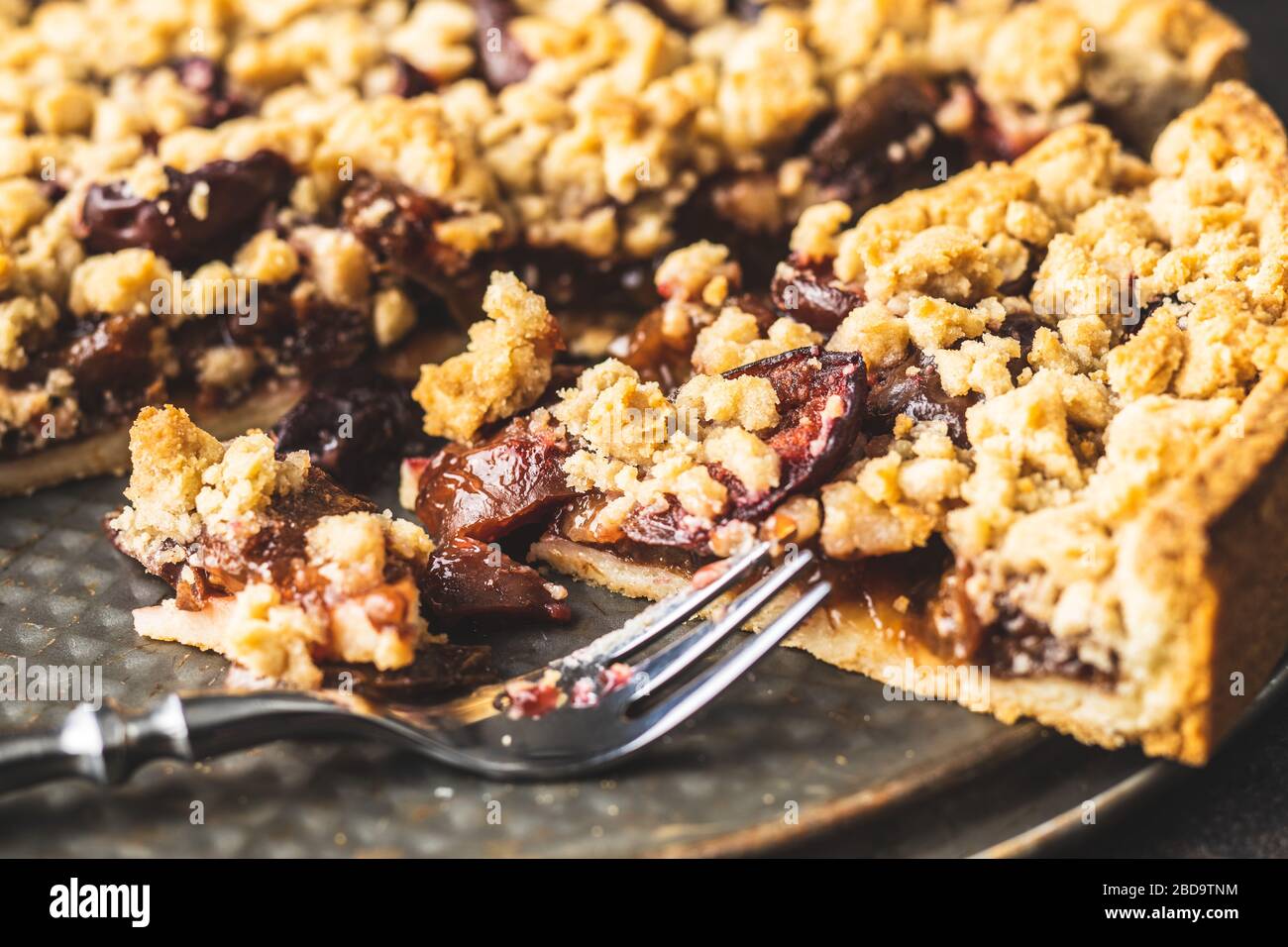 Sweet plum pie. Cut pie on plate. Stock Photo