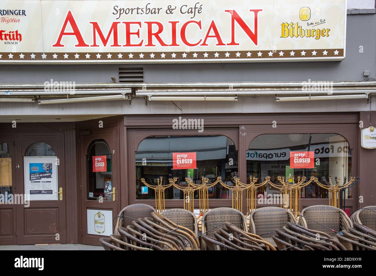 Neuwied, Germany - April 3, 2020: closed pub 'American'  with stacked chairs and tables in front based on Corona pandemic Stock Photo