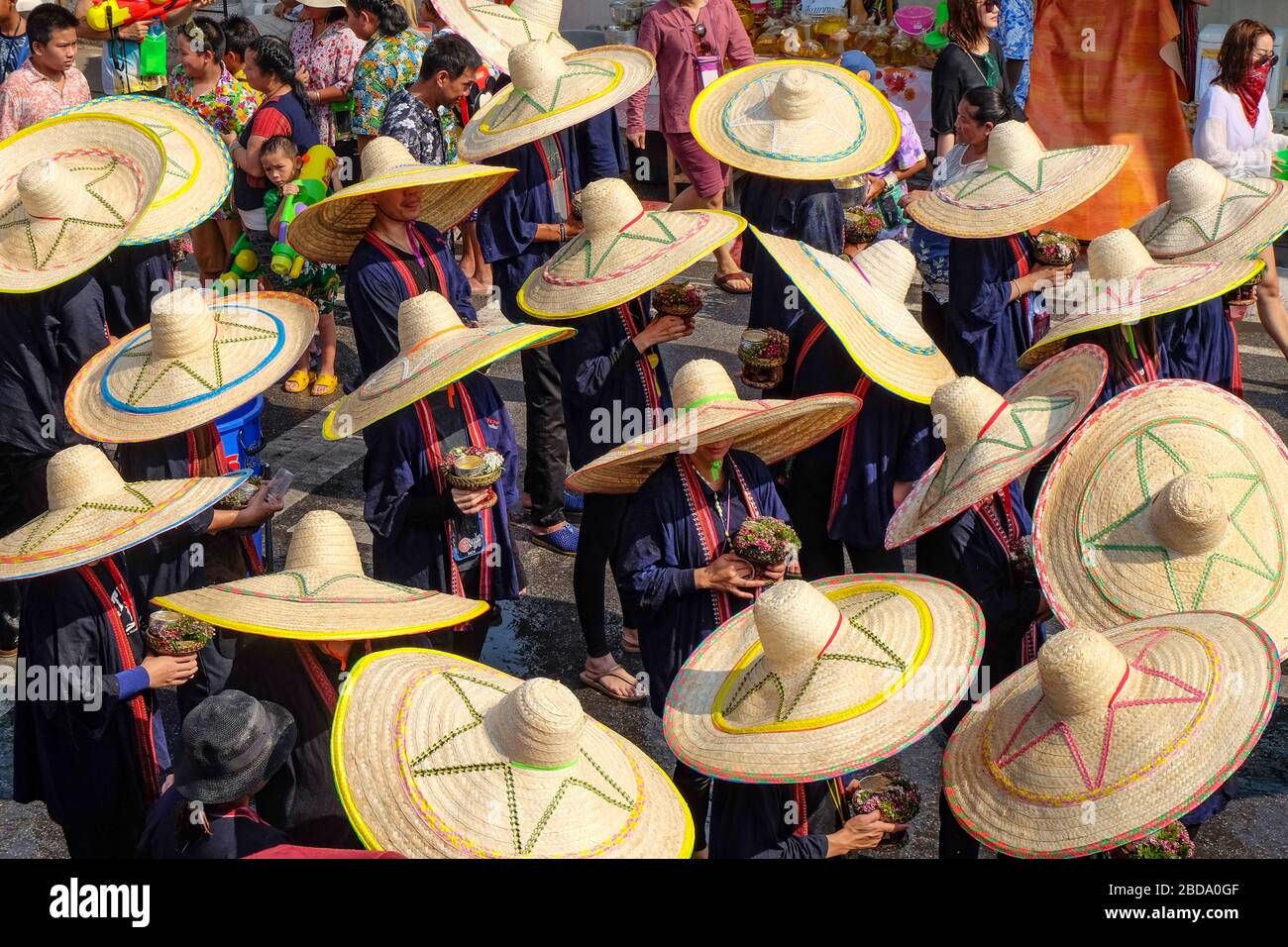 Chiang Mai, Thailand - April 13, 2018. Particiapnts in the parade wearing wide-brimmed hats. Stock Photo