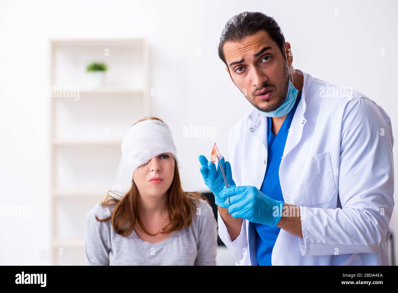 Young Injured Woman Visiting Young Male Doctor Stock Photo - Alamy