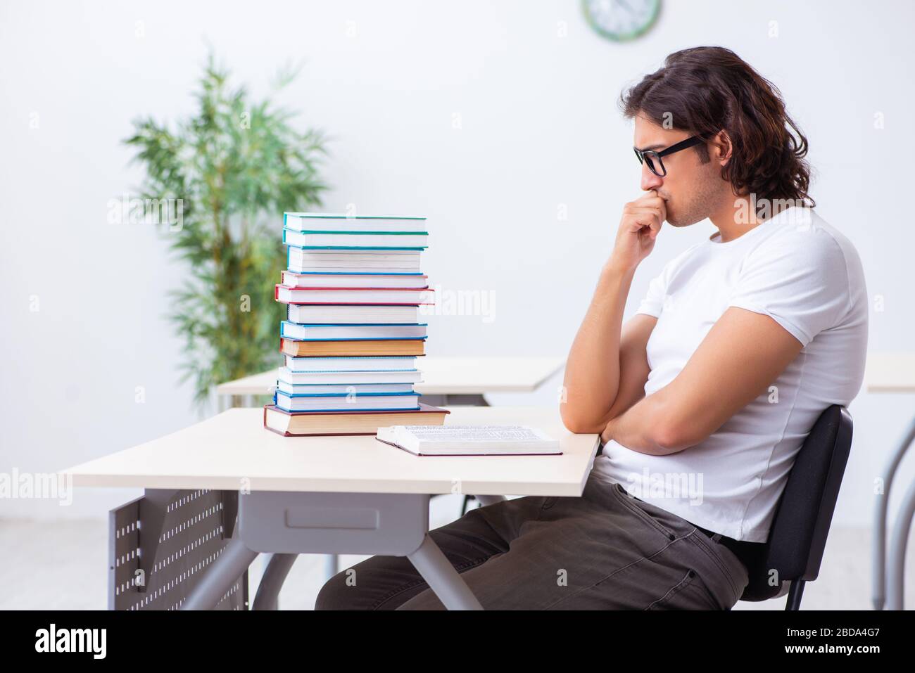 The young male student sitting in the classroom Stock Photo - Alamy
