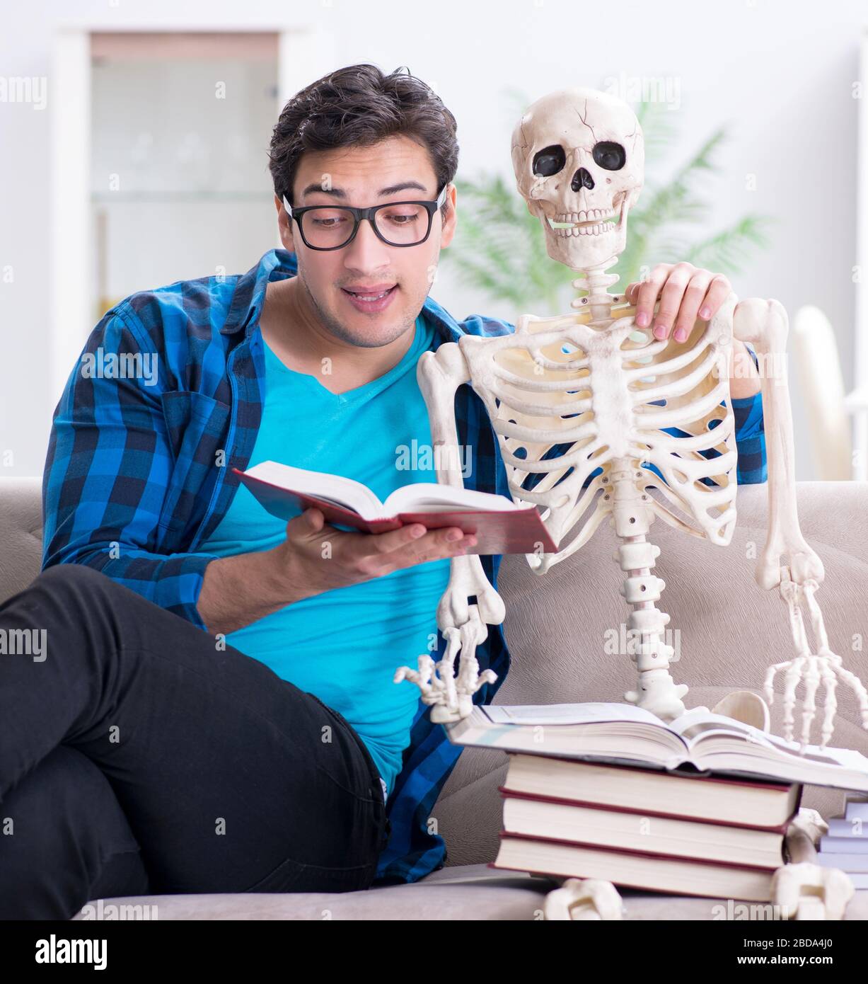 The student studying with skeleton preparing for exams Stock Photo