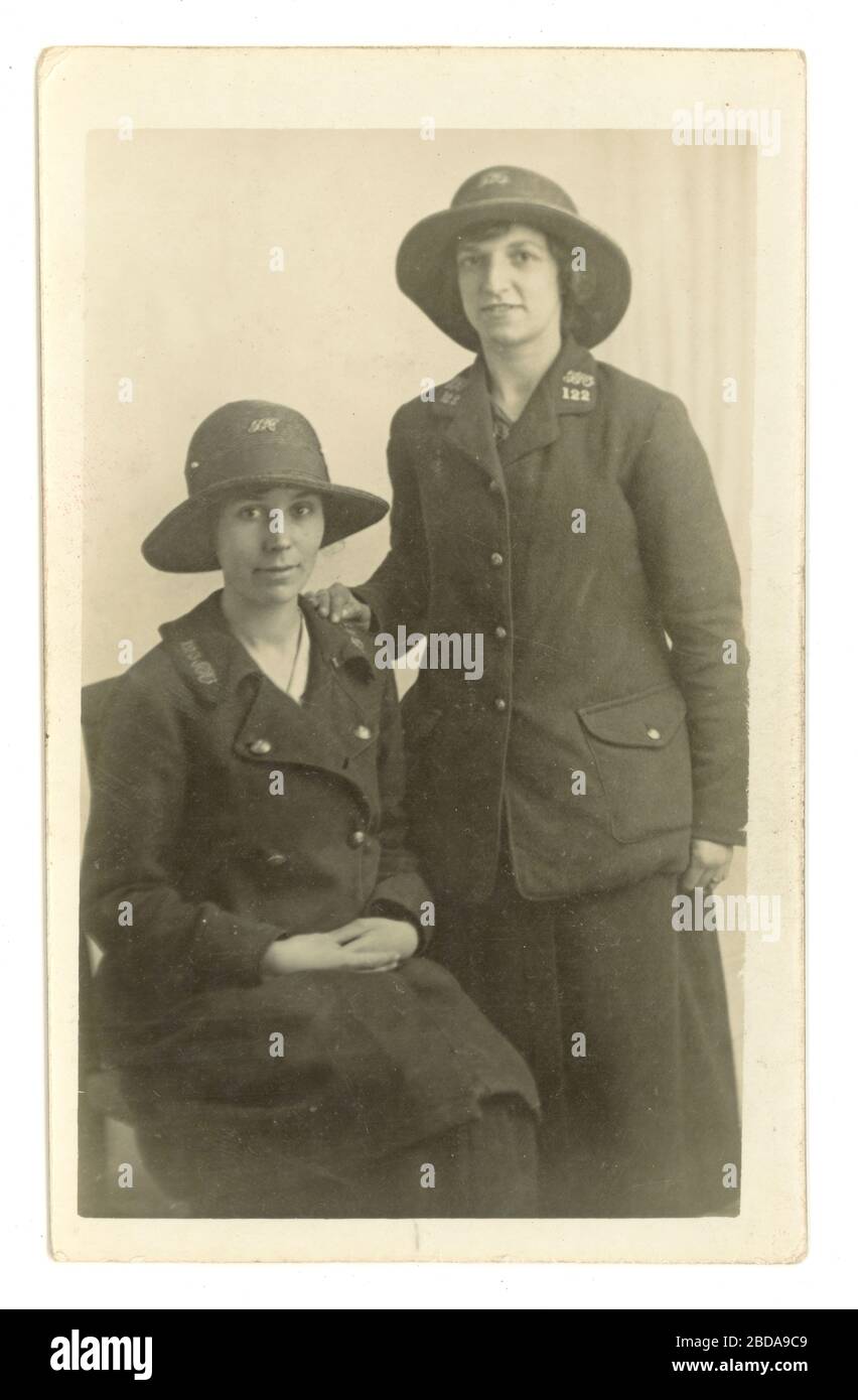Early 1900's studio portrait postcard of two young women  - General Post Office (GPO) postal workers / postwomen - helping deliver letters to aid the war effort on the home front, circa 1916 U.K. Stock Photo