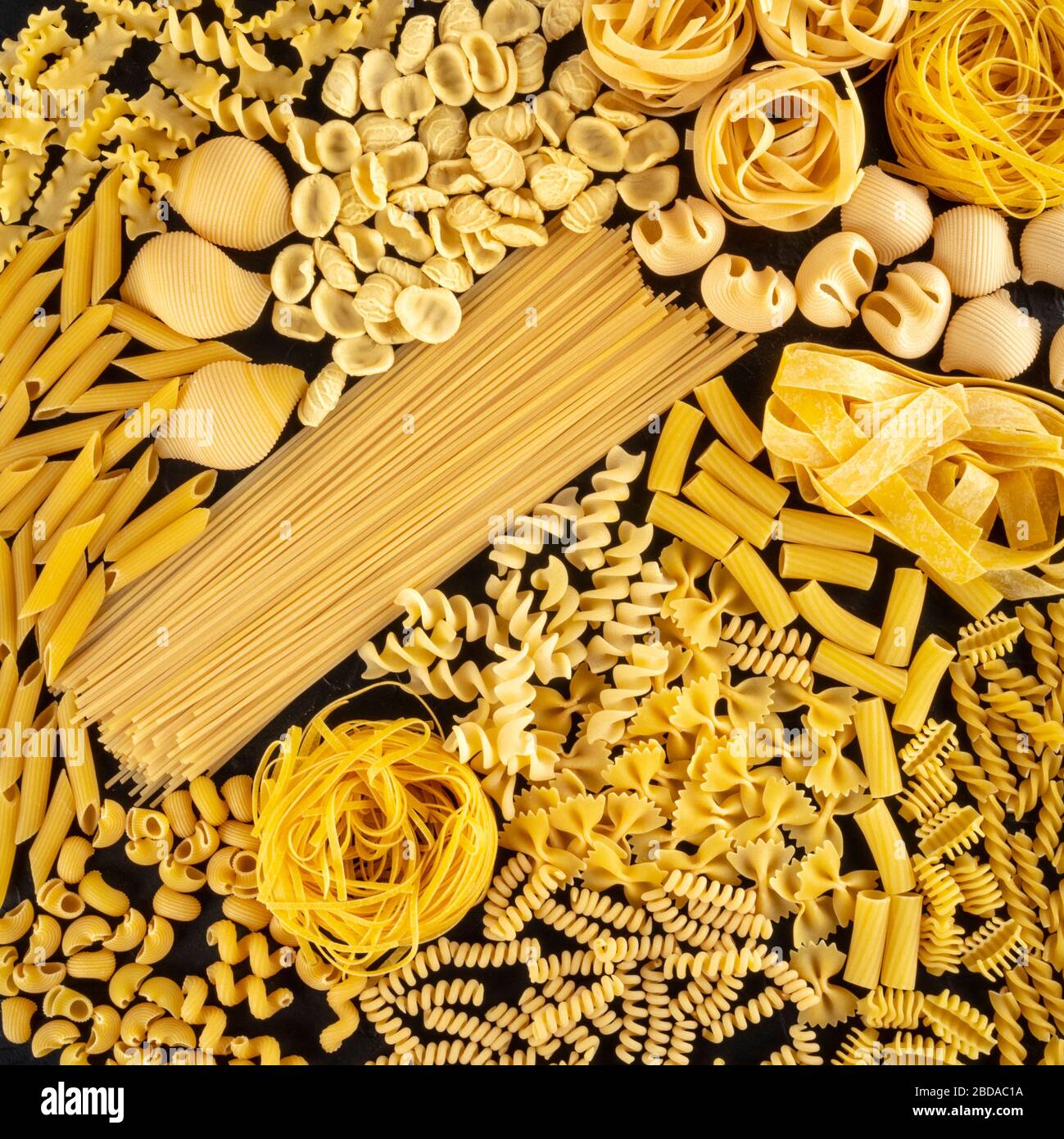 Italian pasta square background texture, a flat lay of many different pasta  types, shot from the top on a black background Stock Photo - Alamy