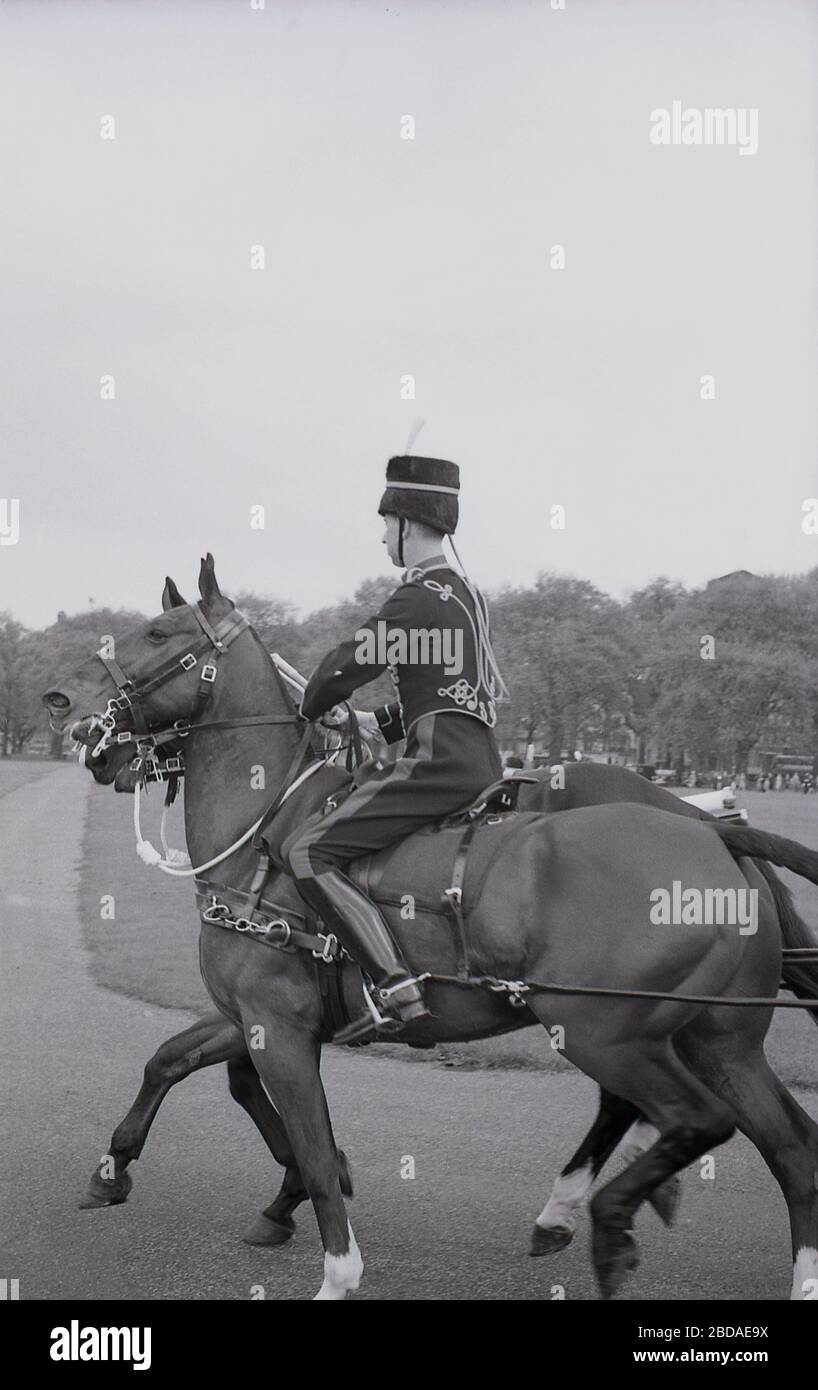 1960s, historical, horse and rider at a Royal gun Salute at Green Park near Buckingham Palace, Westminster, London, England. Gun salutes mark special royal occasions including the Queen's birthday and are a tradition display of British pageantry. Stock Photo