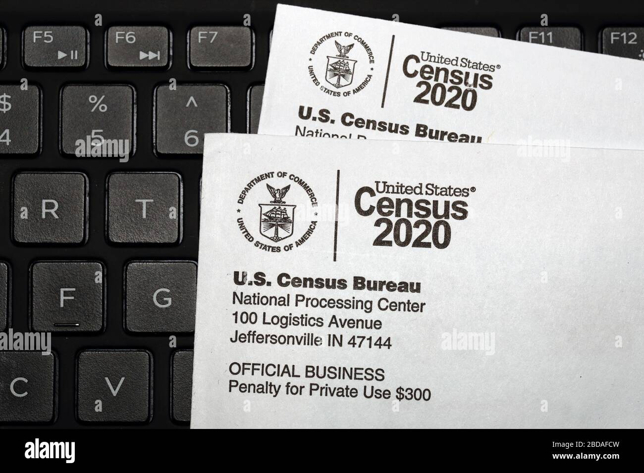 U.S. Census 2020 Census letters laid on top of a computer keyboard.  The questionaire is answered online, census day is April 1. Stock Photo