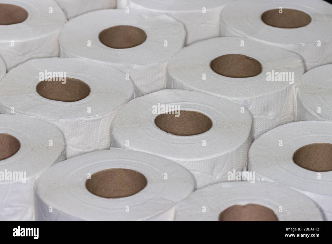 Layer of white toilet paper rolls seen from angle above filling frame Stock Photo