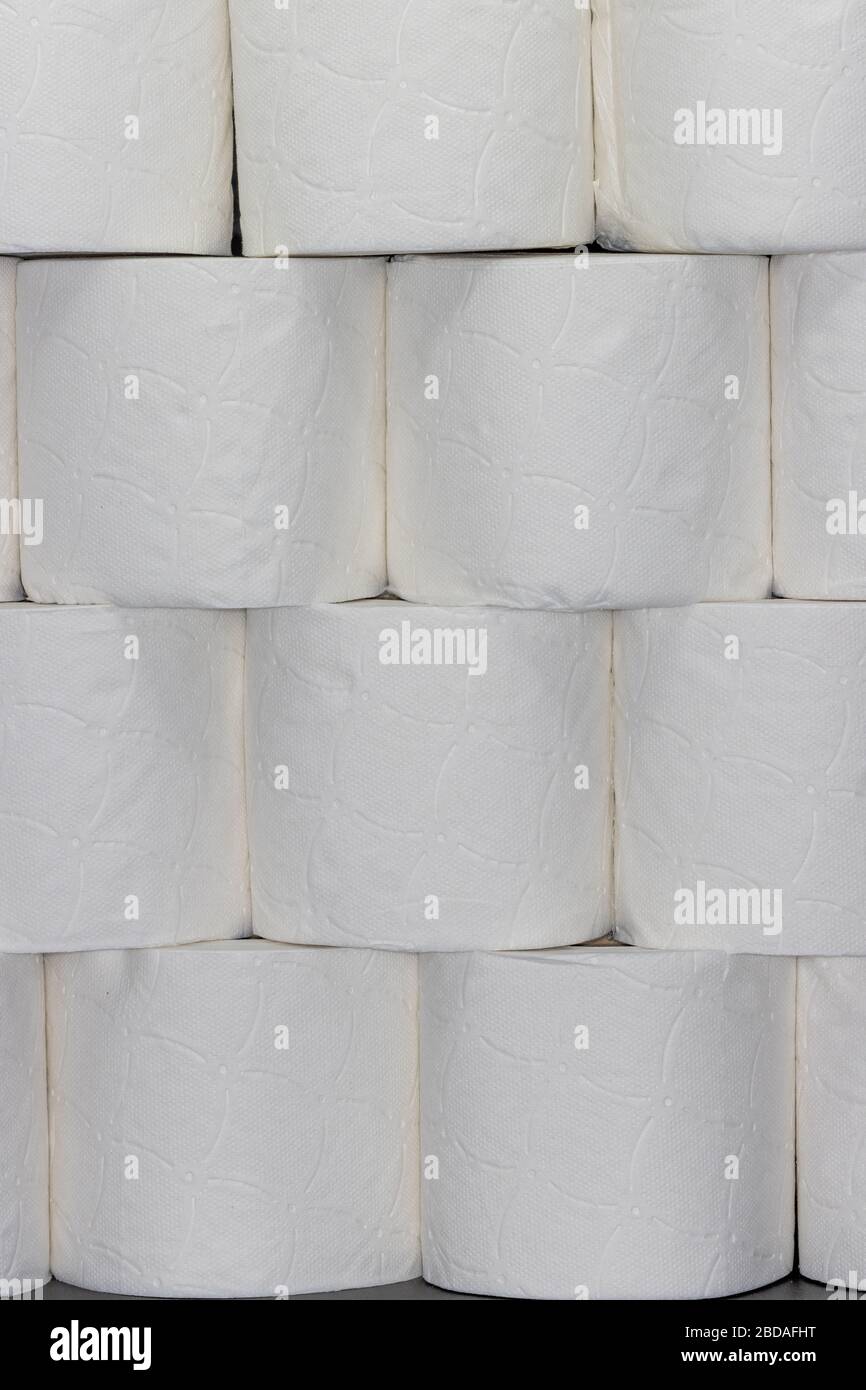 Wall of stacked white toilet paper rolls Stock Photo