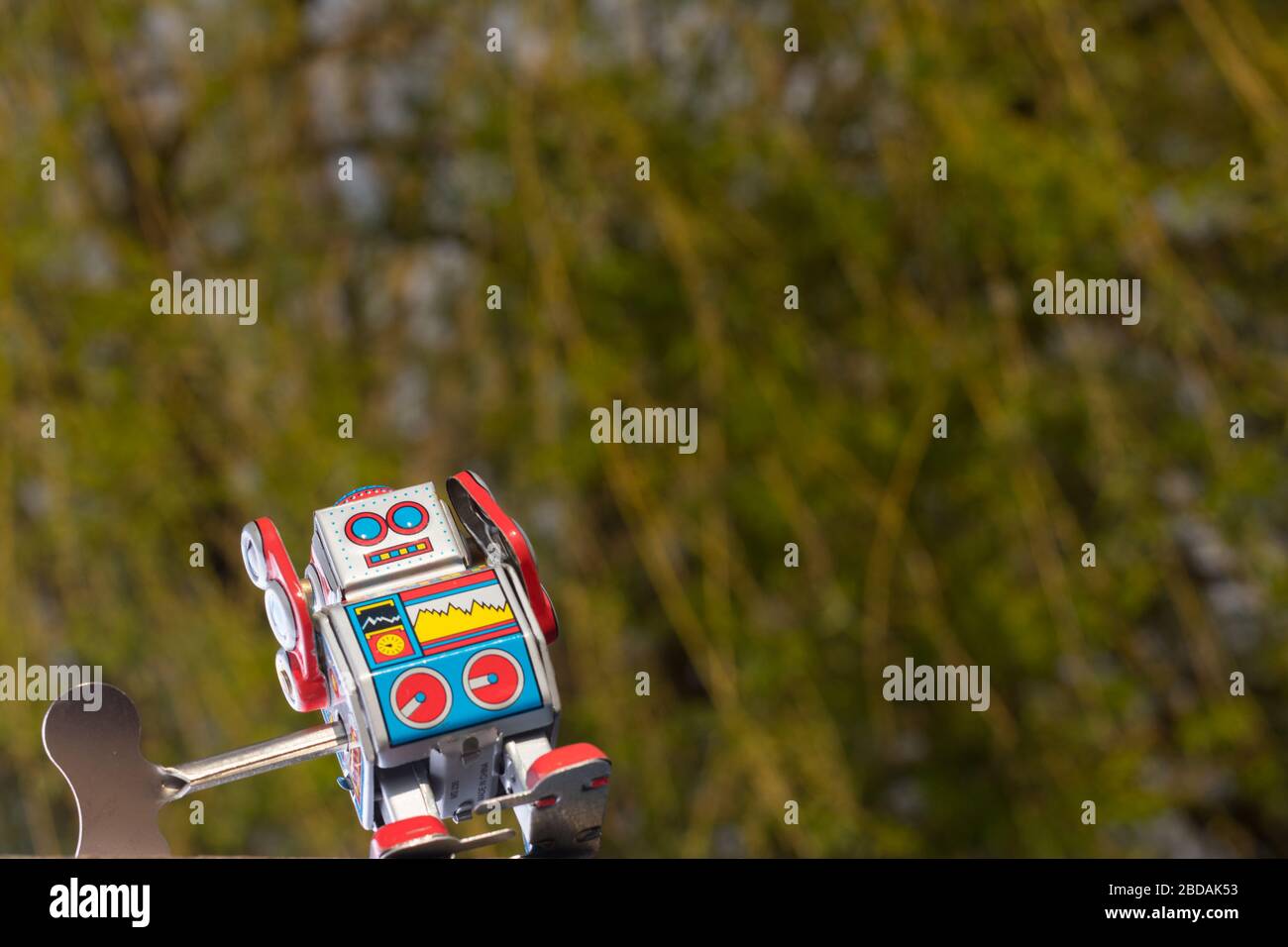 Vintage toy robot with sky behind. Artificial intelligence concept. Stock Photo
