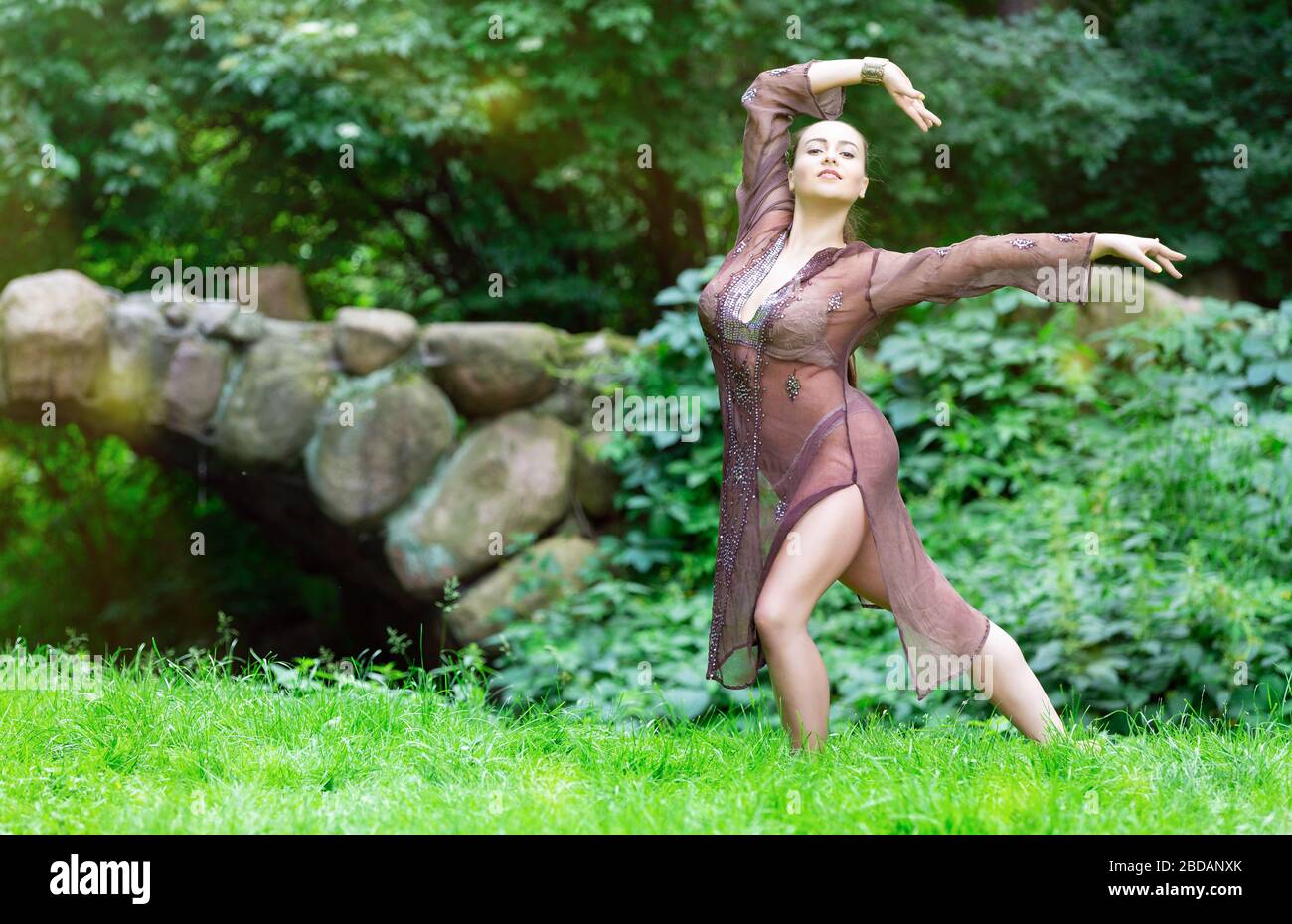 Beautiful dancing woman in the spring park Stock Photo