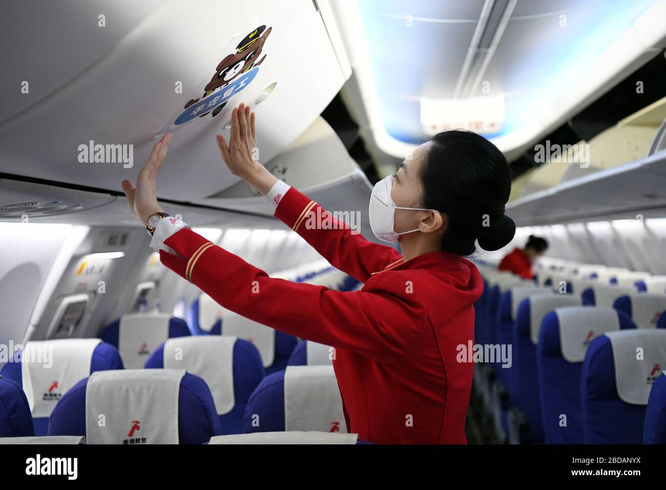 Shenzhen, China's Guangdong Province. 8th Apr, 2020. Stewardesses make preparations on flight ZH9127 of Shenzhen Airlines at the Baoan International Airport in Shenzhen, south China's Guangdong Province, April 8, 2020. Flight ZH9127 was the first flying from Shenzhen to Wuhan, after Wuhan, capital of central China's Hubei Province, lifted outbound travel restrictions from Wednesday following almost 11 weeks of lockdown to stem the spread of COVID-19. Credit: Liang Xu/Xinhua/Alamy Live News Stock Photo
