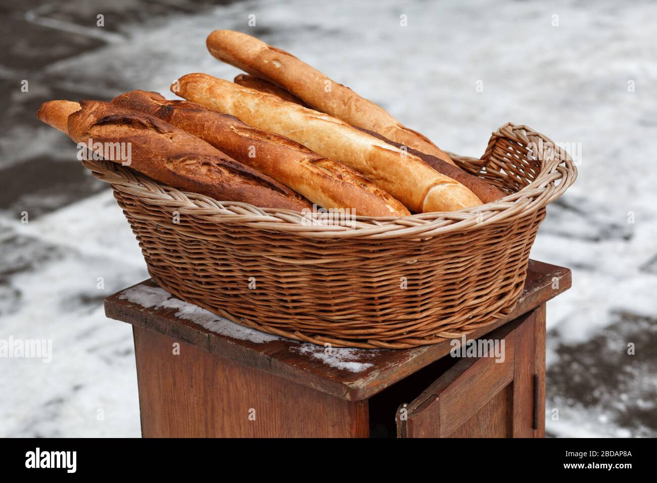 French baguettes in a wicker basket Stock Photo - Alamy
