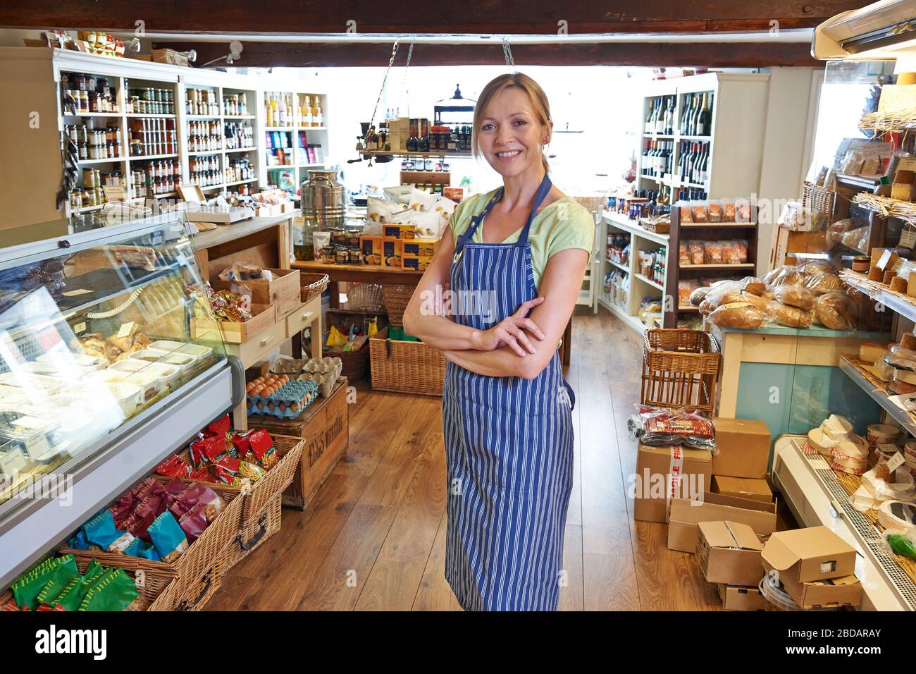 Portrait Of Female Owner Of Delicatessen Standing In Shop Stock Photo