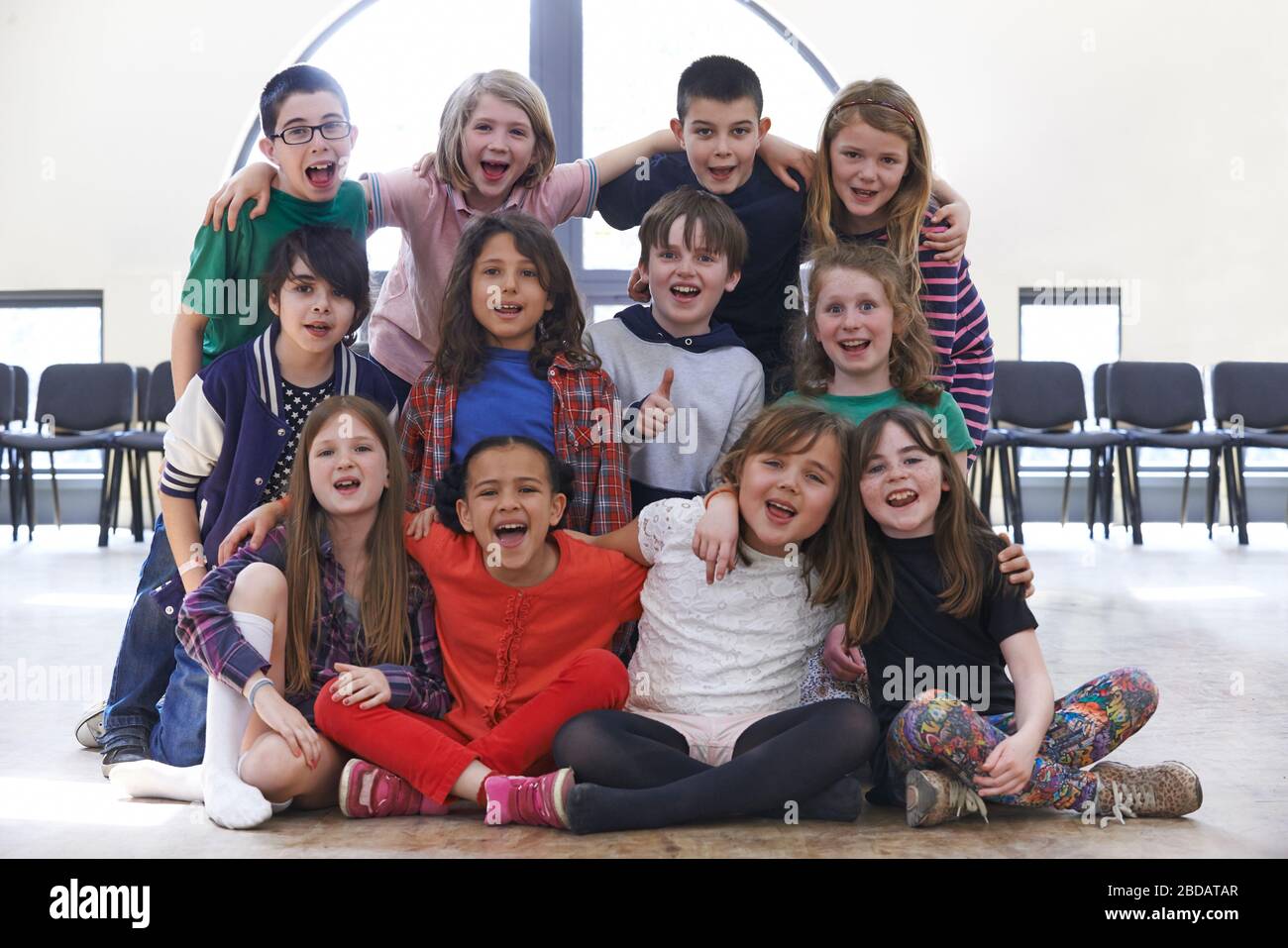Portrait Of Group Of Children Enjoying Drama Workshop Together Stock Photo