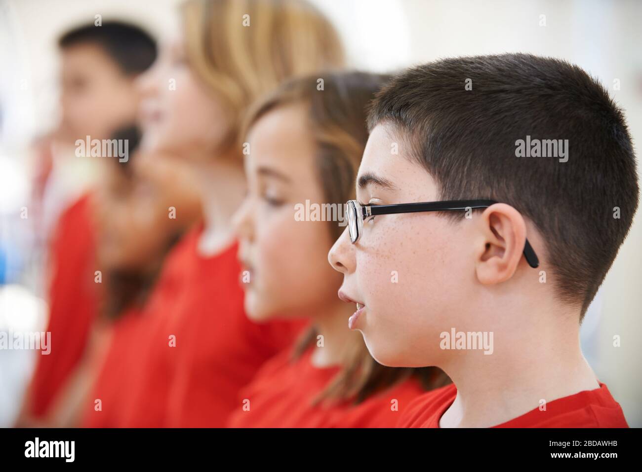 Group Of School Children Singing In Choir At Stage School Together Stock Photo