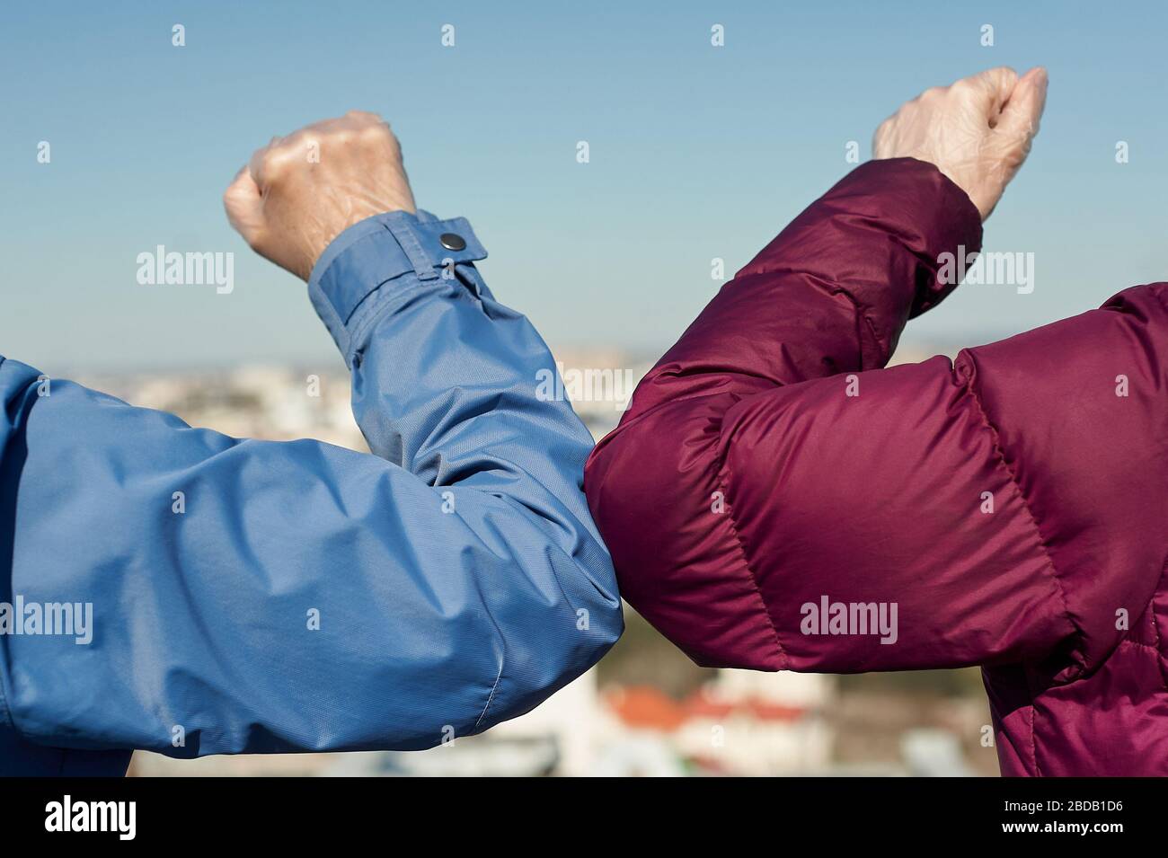 Elbow bump. Greeting with no hand touching. Elbow greeting in quarantine concept. Stock Photo