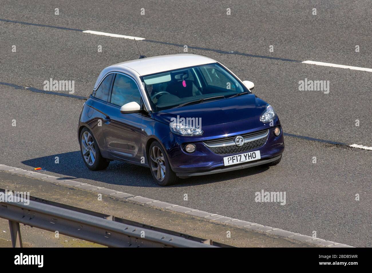 2017 blue white Vauxhall Adam Slam; Vehicular traffic moving vehicles, driving vehicle on UK roads, motors, motoring on the M6 motorway highway Stock Photo