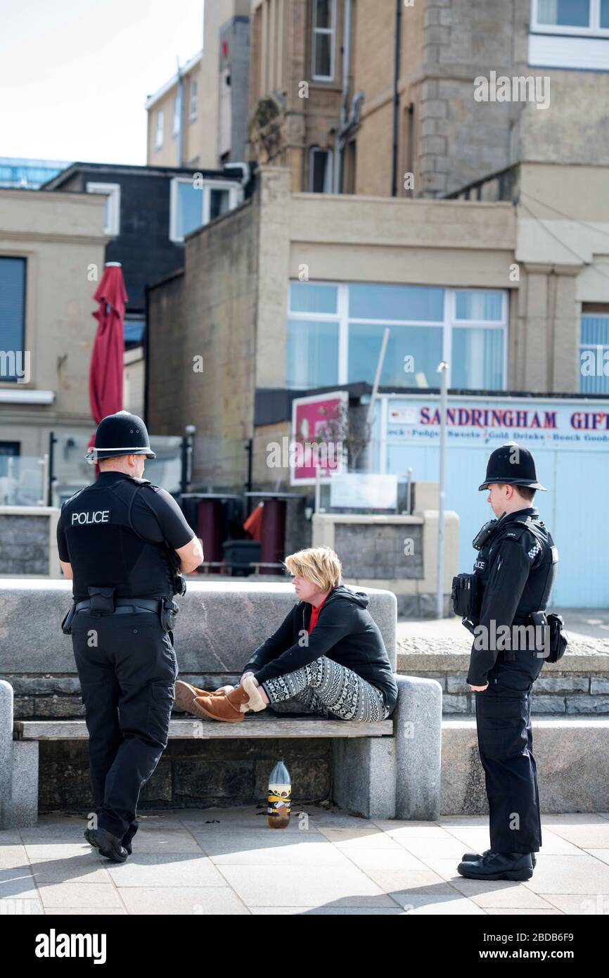 Police instruct a homeless person to return to her accomodation in Weston-super-Mare during the Coronavirus lockdown Stock Photo