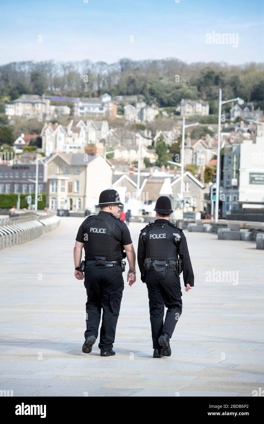 Police patrol the near deserted seafront at Weston-super-Mare during the Coronavirus lockdown UK Stock Photo