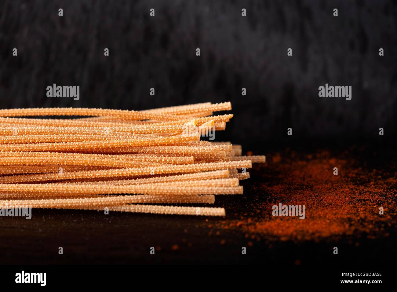 Spaghetti with chili and chili powder on slate Stock Photo