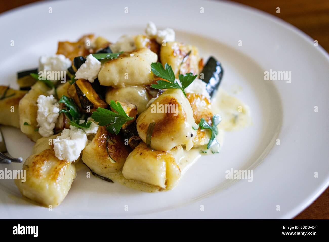 Home made gnocchi with goats cheese and parsley. Stock Photo