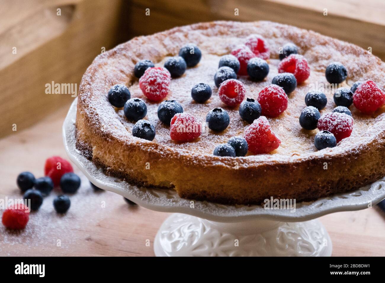 Freshly baked cake with fresh berries on top Stock Photo