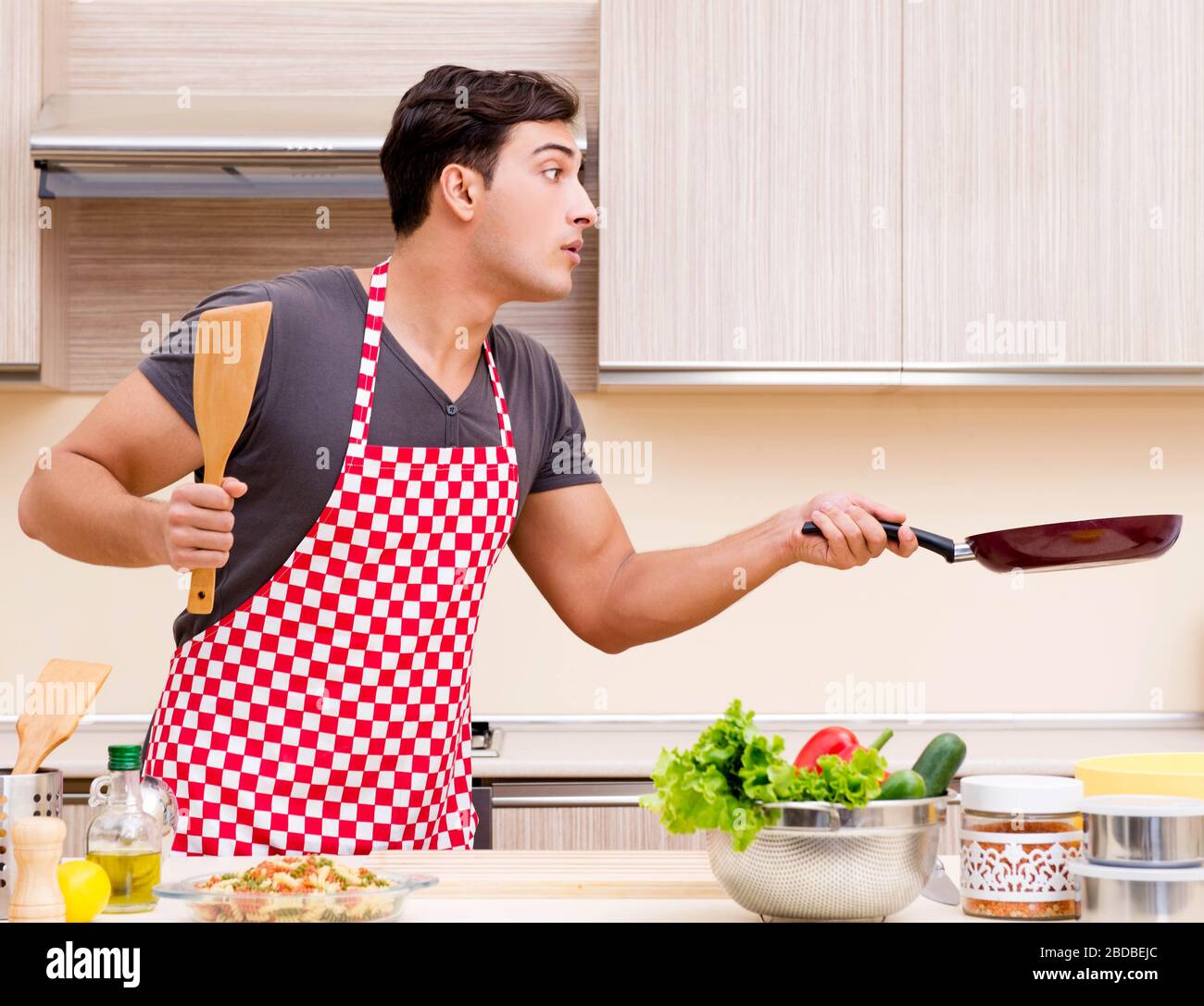 The man male cook preparing food in kitchen Stock Photo - Alamy