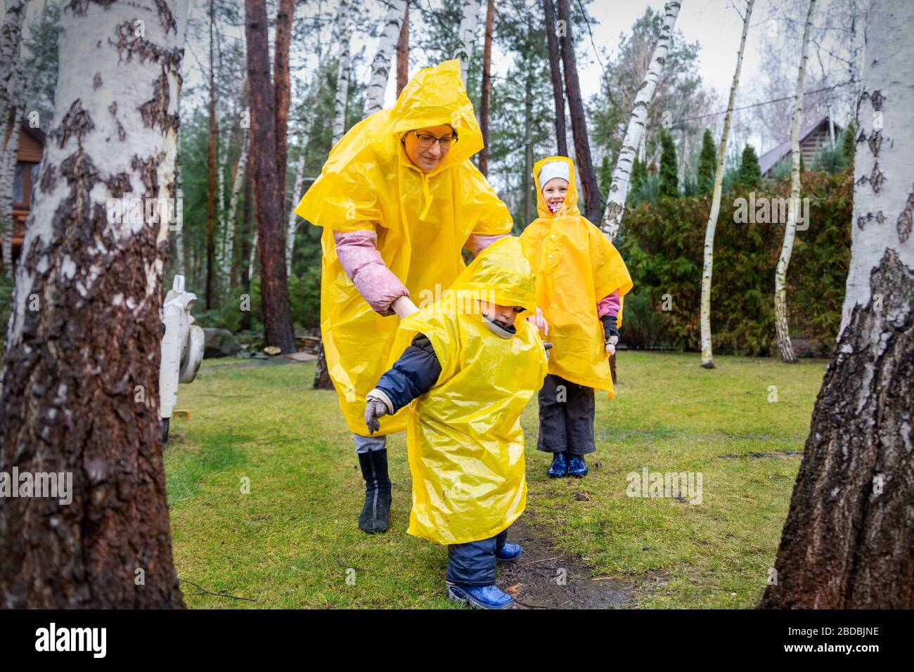 Mother with cute adorable caucasian siblings children in bright yellow