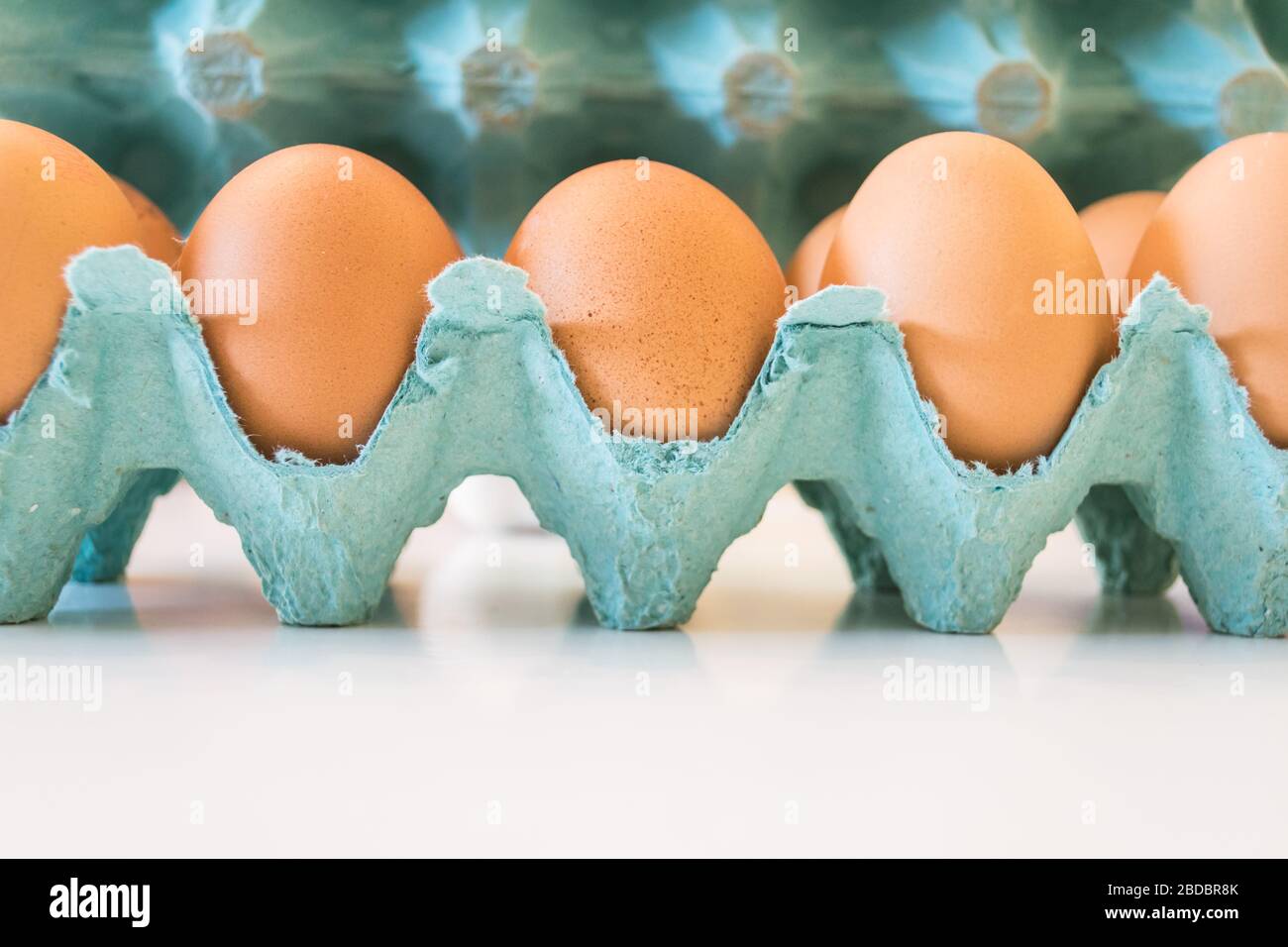 Fresh brown chicken eggs in a green box Stock Photo