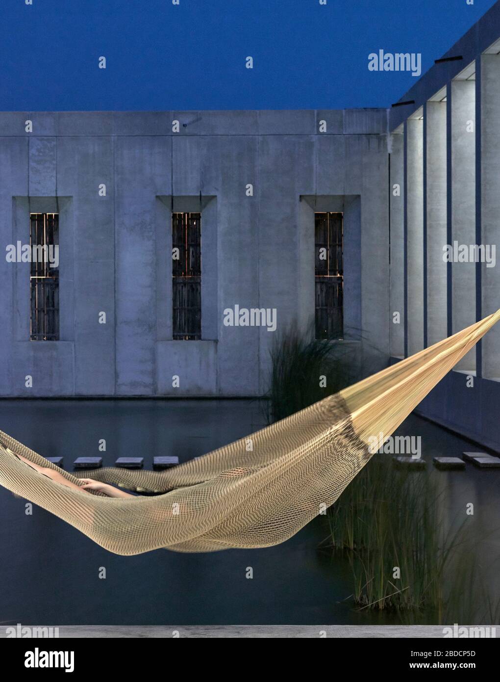 Concrete facade of grand hall with hammock. Plantel Matilde, Yucatan, Mexico. Architect: Javier Marín and Arcadio Marín, 2020. Stock Photo