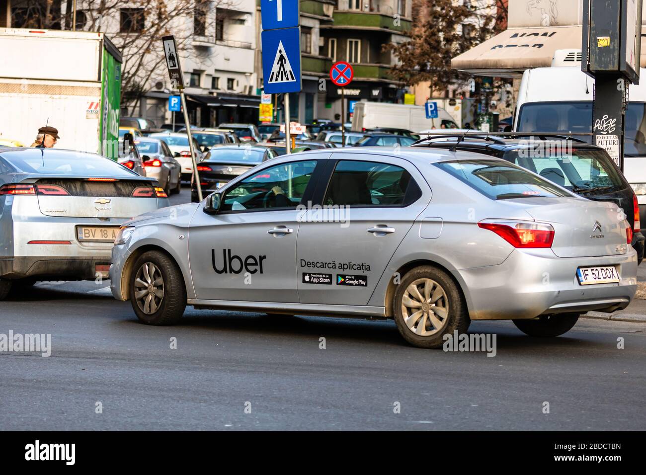 Uber car in traffic, modern city taxi service. Car pollution