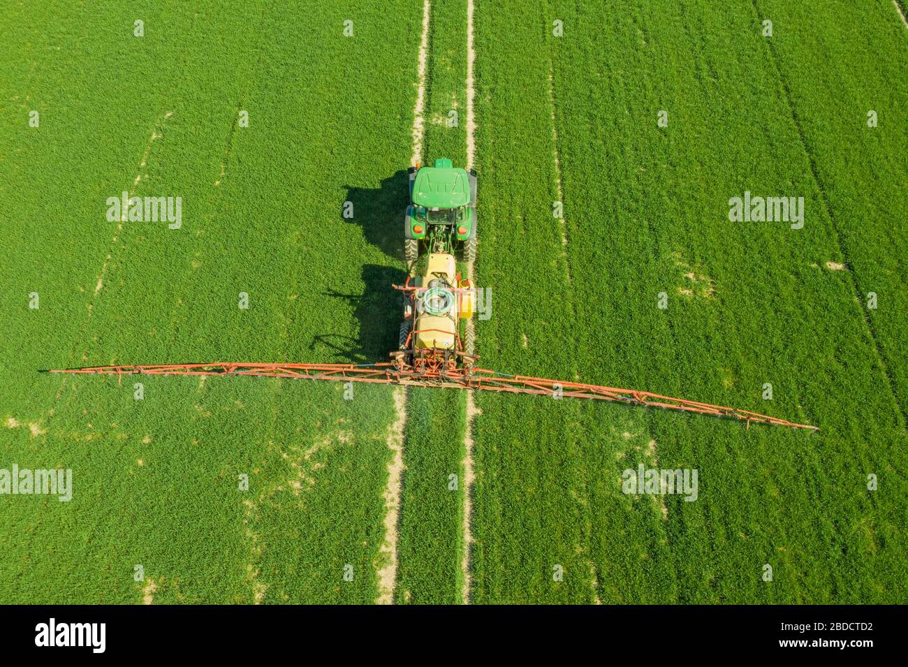 Agriculture Tractor Working in Field Stock Photo - Alamy