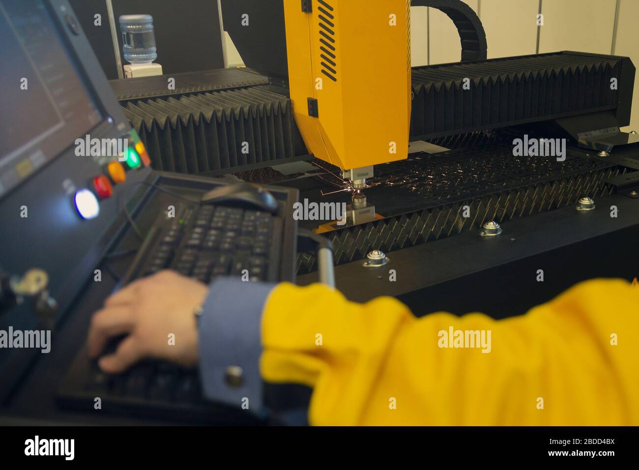Laser cutting and the operator at the control panel, CNC modern ...