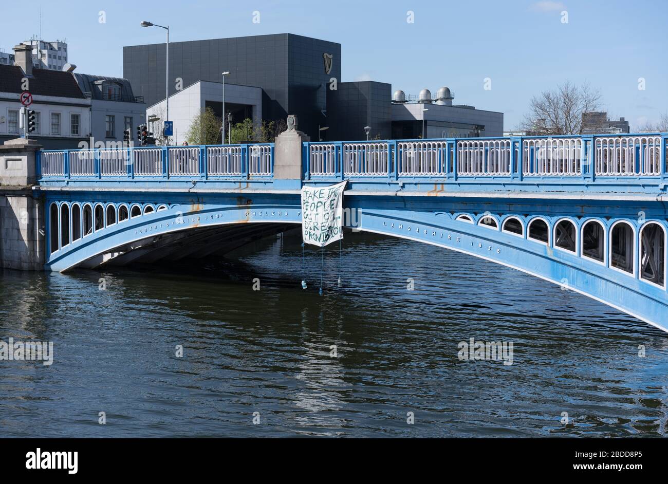 Direct Provision protest banner hanging from bridge in Dublin city, Ireland. Stock Photo