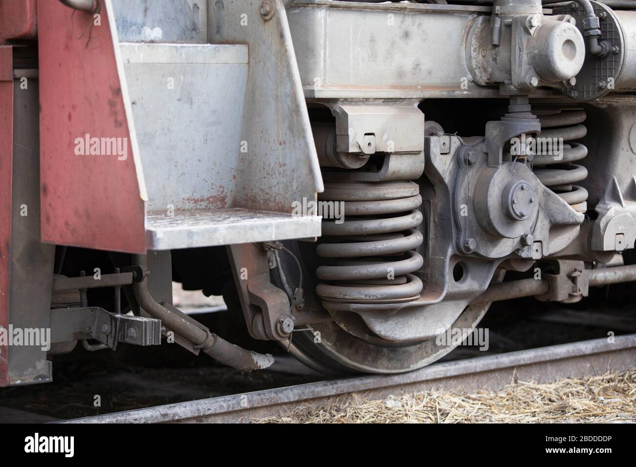 Low angle view of wheel mechanism of modern train locomotive on tracks. Steampunk, techno, power concept. Railroad transport, iron or steel constructi Stock Photo