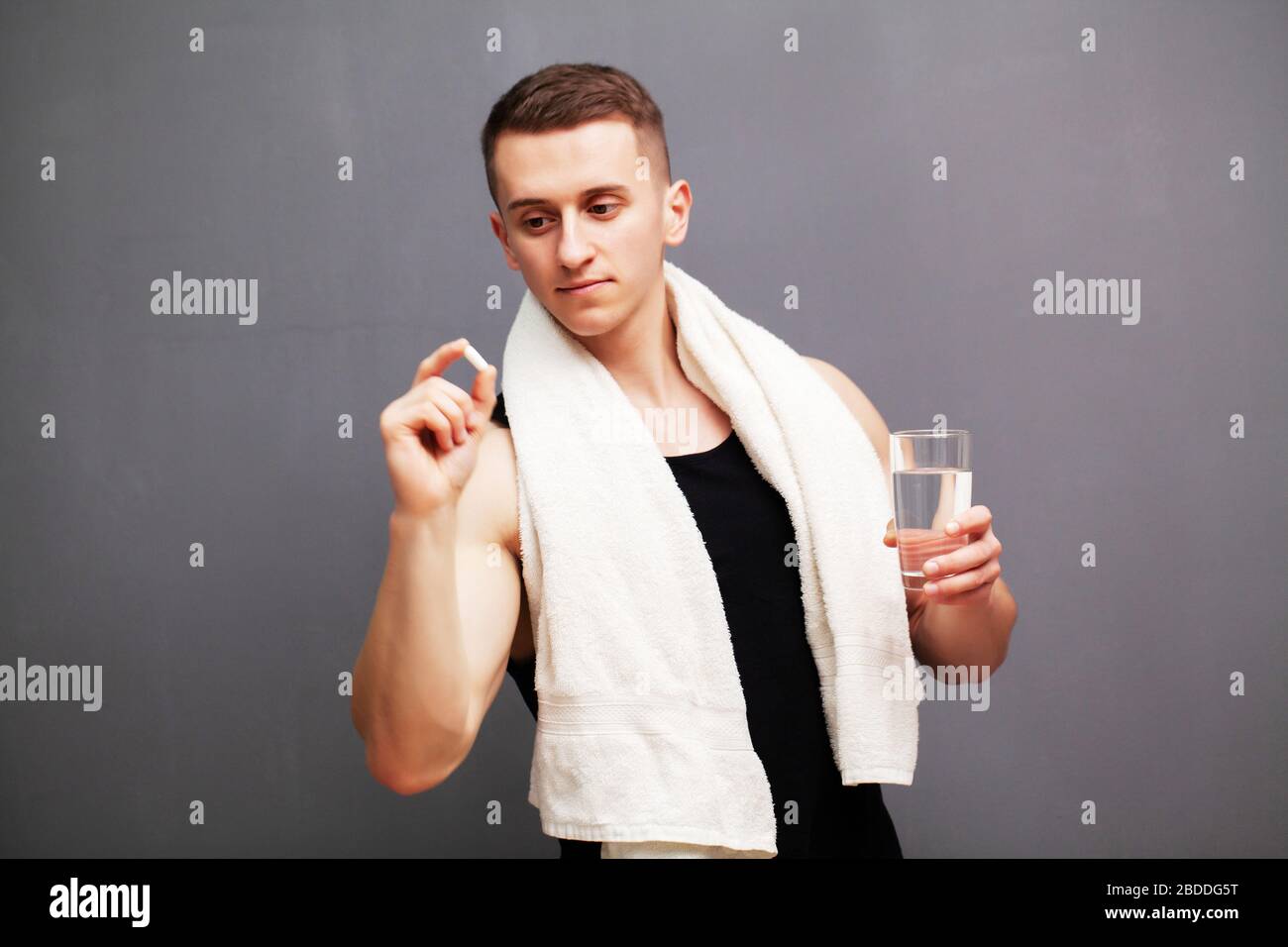 Man takes a pill of amino acids after training Stock Photo Alamy