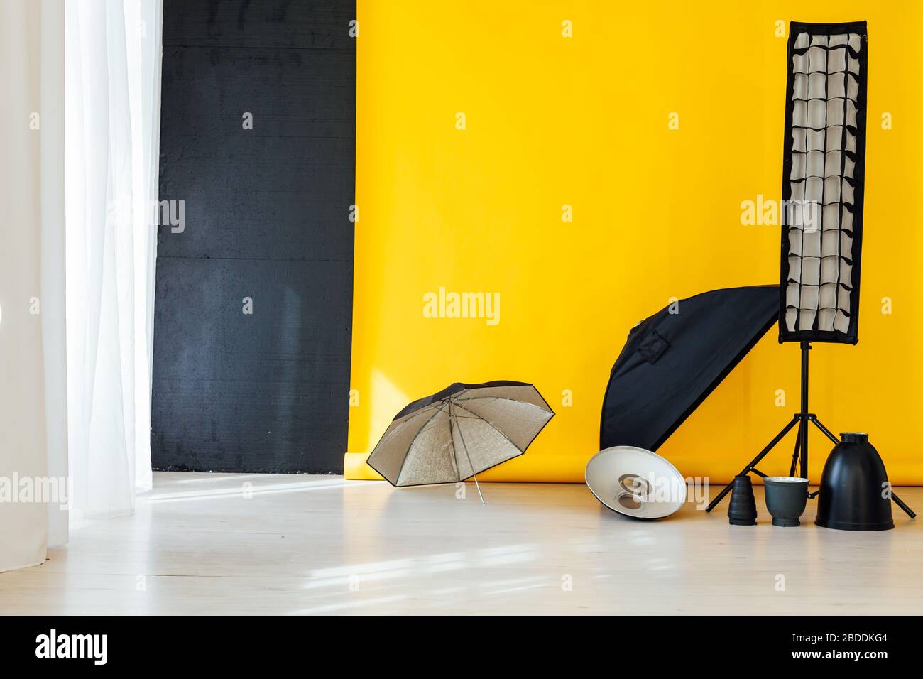 flash and accessories photo studio with yellow background Stock Photo Alamy