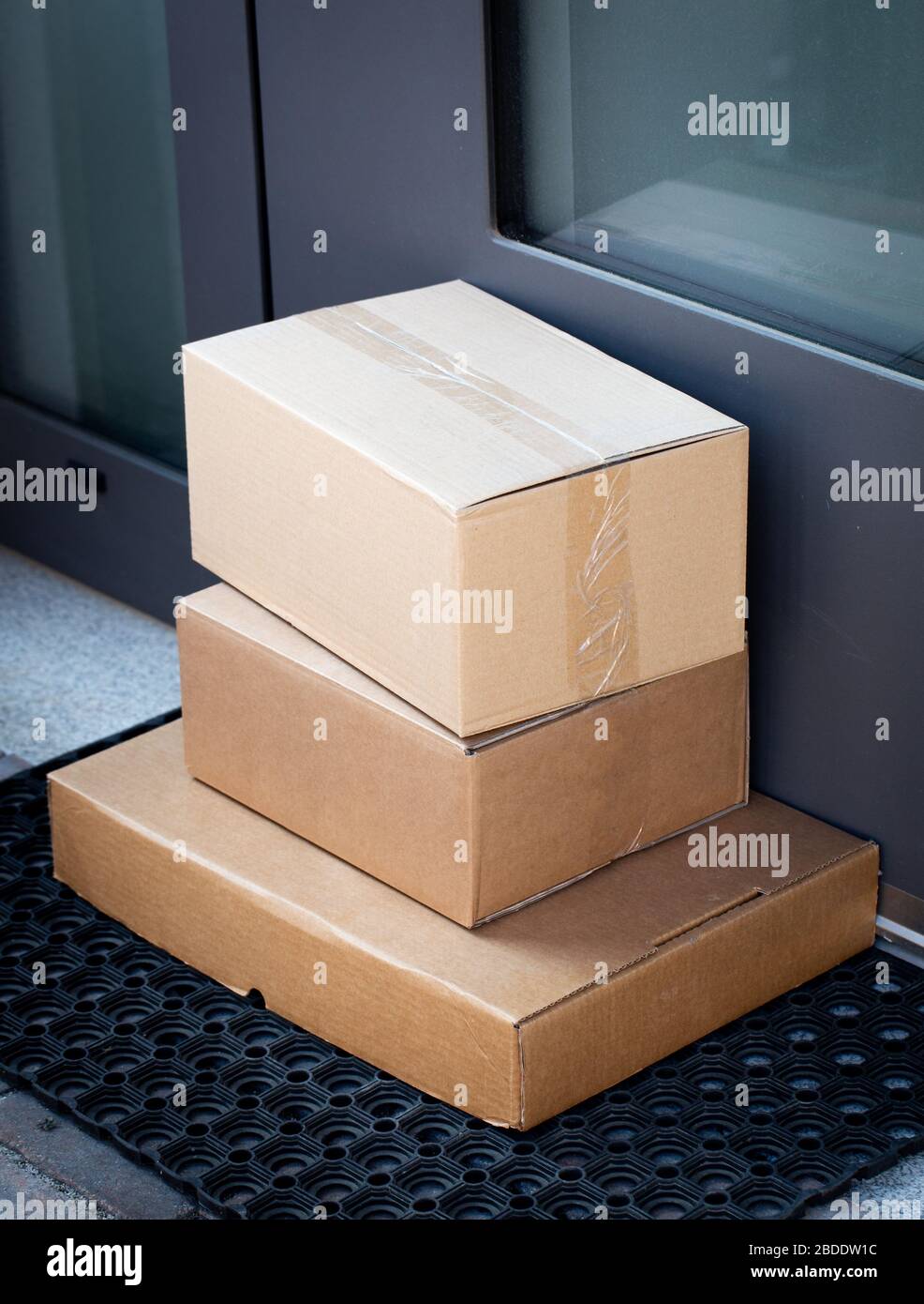 Packages left at front door for contactless delivery of online bought items Stock Photo