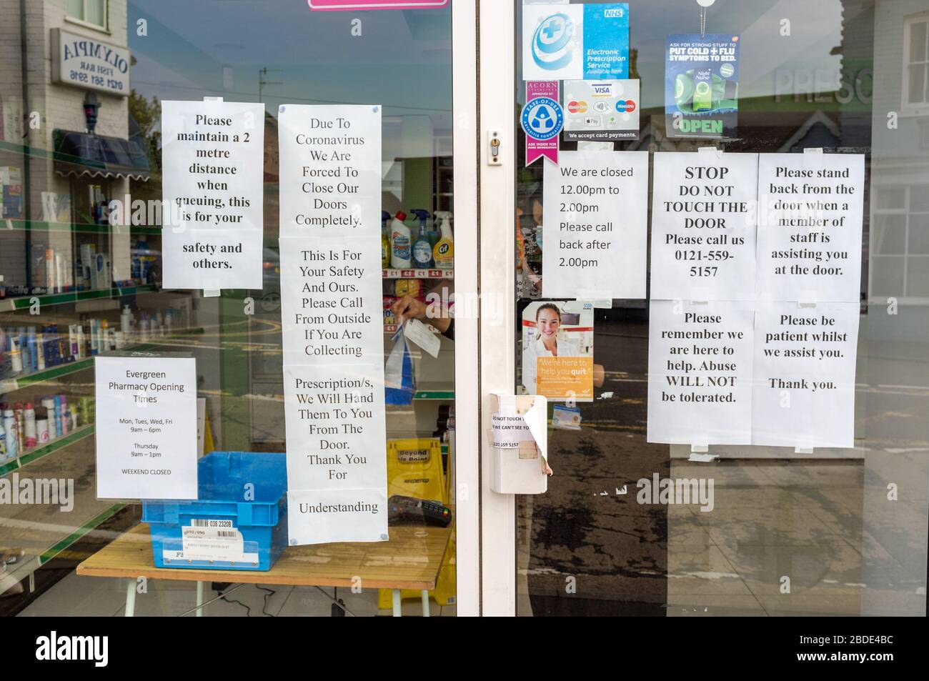 Notices on a pharmacy or chemist during the 2020 Coronavirus COVID 19 outbreak, UK Stock Photo