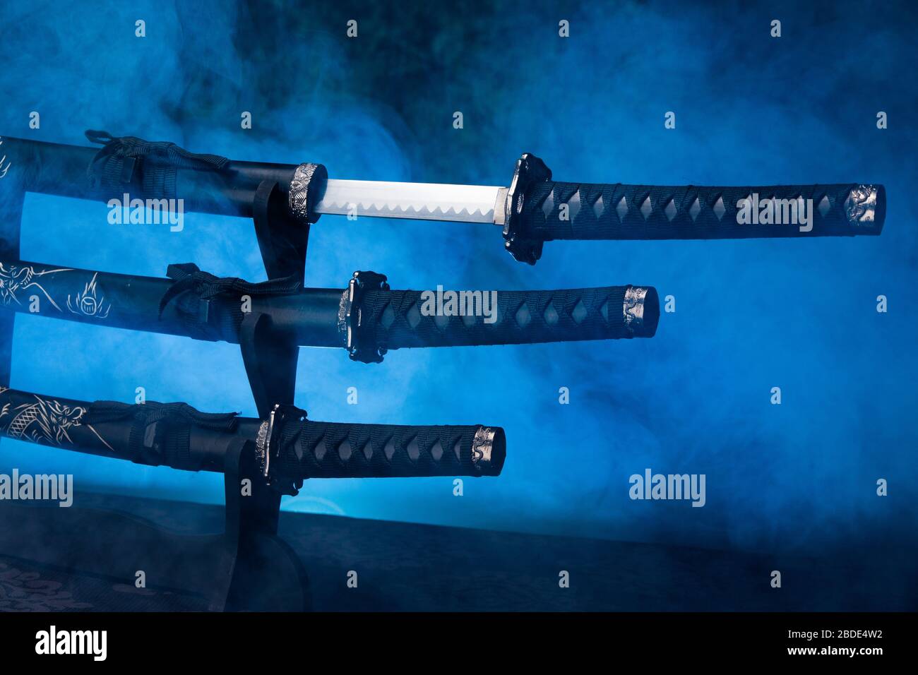 Stand with katana, wakizashi and tanto swords, first one partially exposed Stock Photo