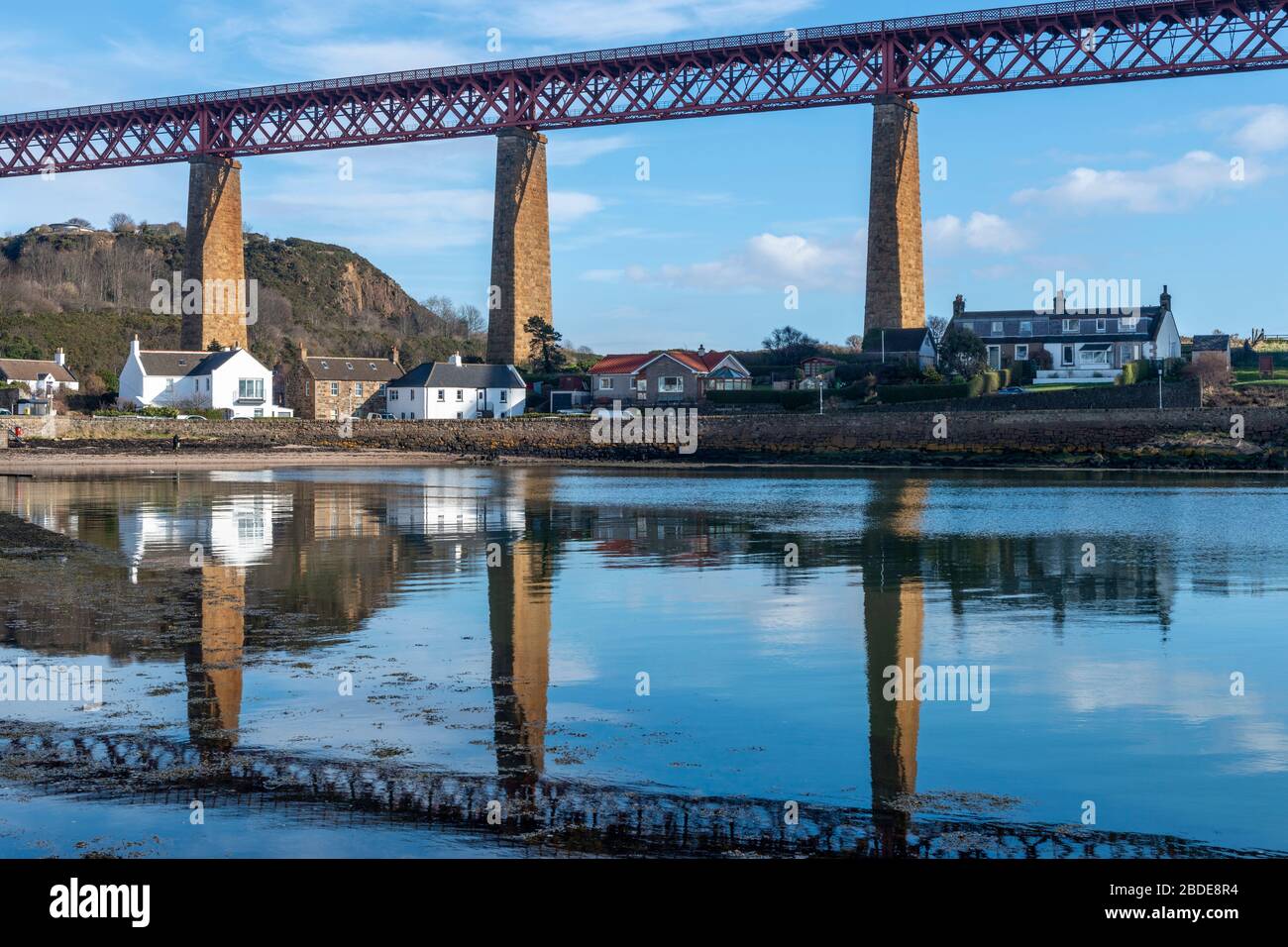 Houses on Battery Road on South Bay under the approach spans of the Forth Rail Bridge - North Queensferry, Fife, Scotland, UK Stock Photo