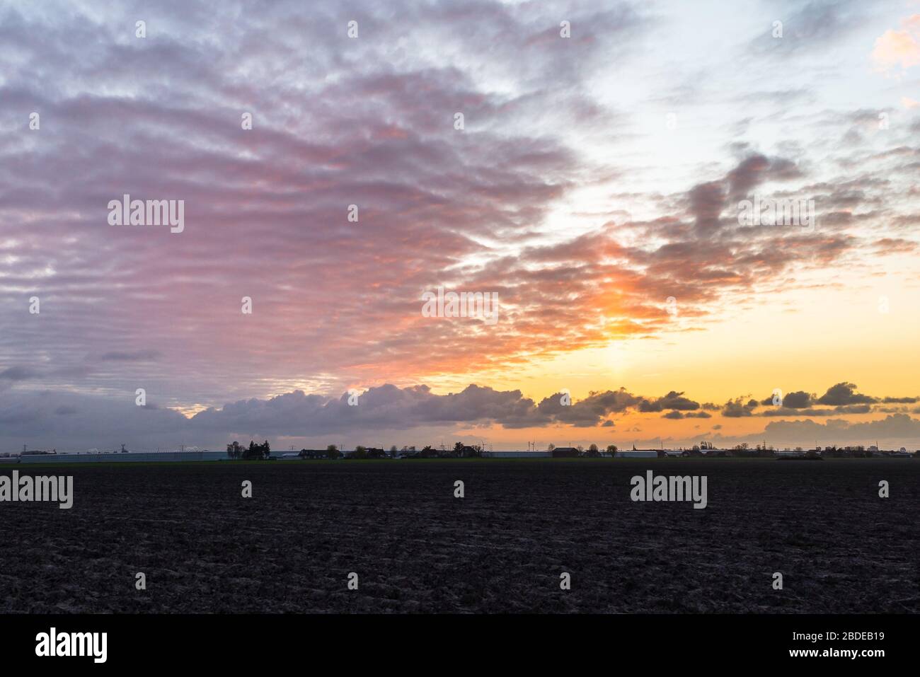 Stunning colors in the sky over the wide open and flat landscape of the province of South Holland (dutch: Zuid-Holland) Stock Photo