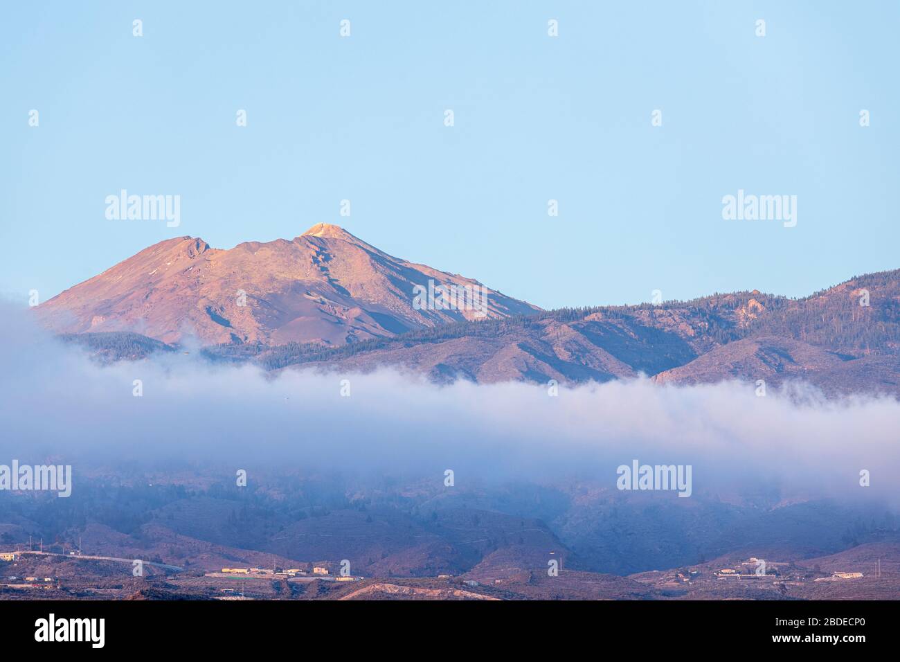 Teide volcano and the Pico Viejo above the cloud, viewed from Playa San Juan, Tenerife, Canary Islands, Spain Stock Photo