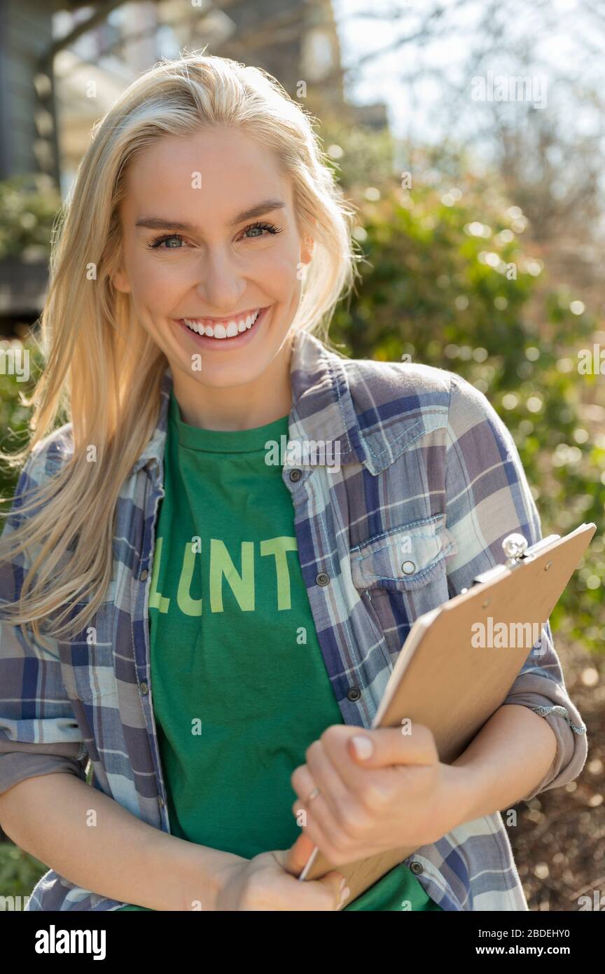 Smiling woman holding clipboard Stock Photo