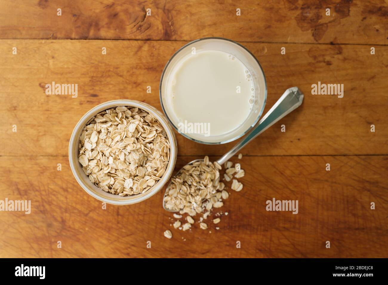 Oats and oat milk against wood Stock Photo Alamy